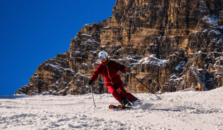 Woman in red skiing in Dolomites