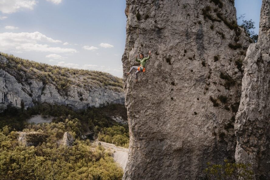 Woman smiling while climbing