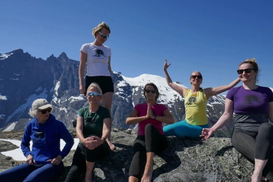 Women hikers doing yoga in Norway