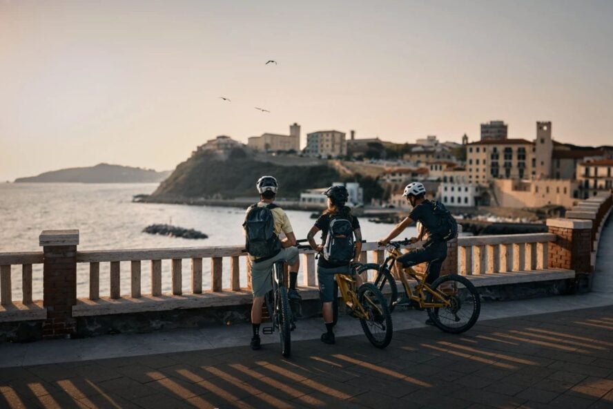 Three bikers on a bridge in Tuscany
