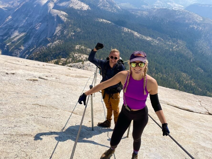 Two hikers smiling Half Dome cables