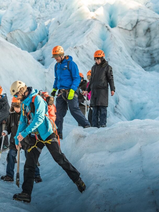 four hikers on a glacier
