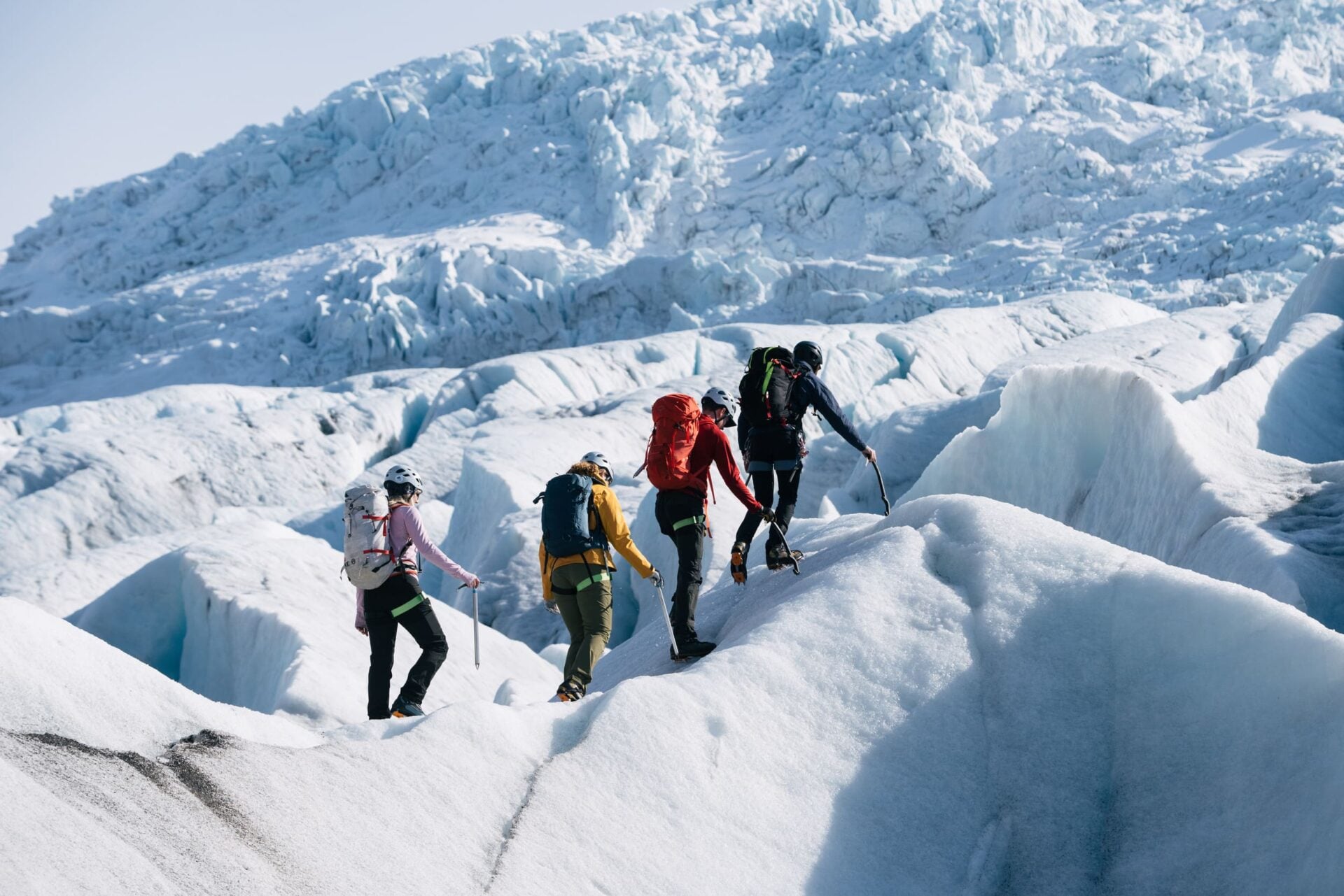 four hikers on a glacier