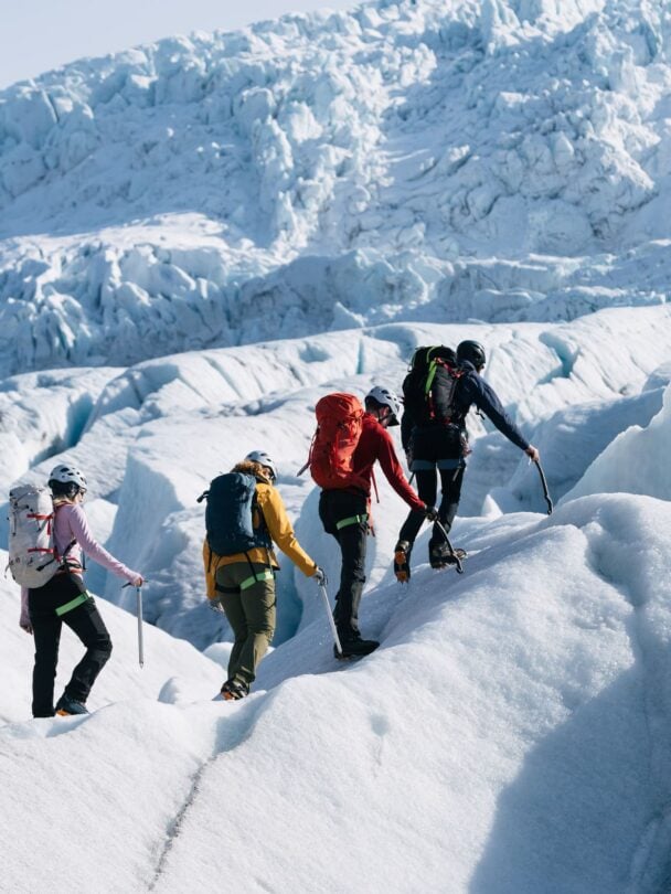 four hikers on a glacier
