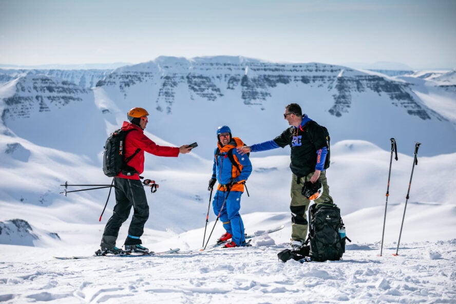 Skiers in Iceland with a phone
