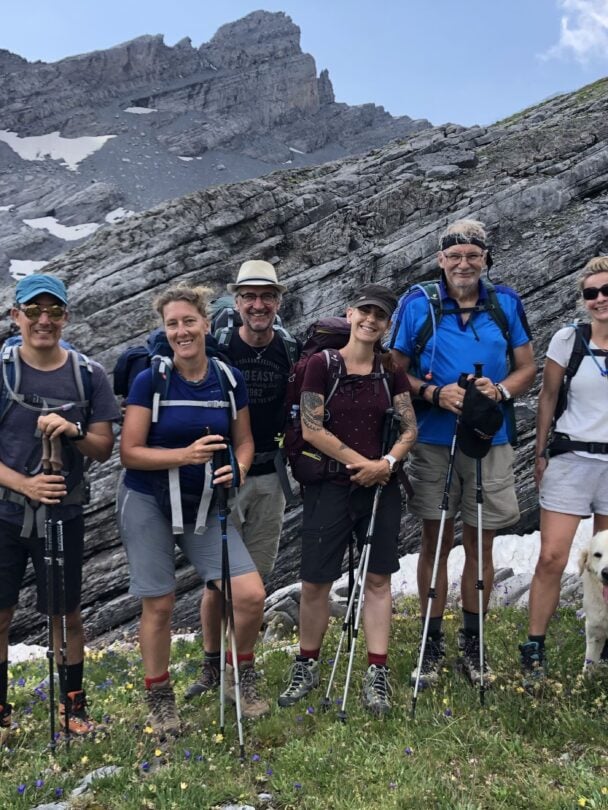 happy group in switzerland with a dog