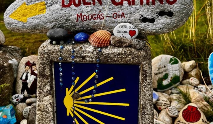 Image 4: Buen Camino stone marker decorated with shells and pilgrim keepsakes