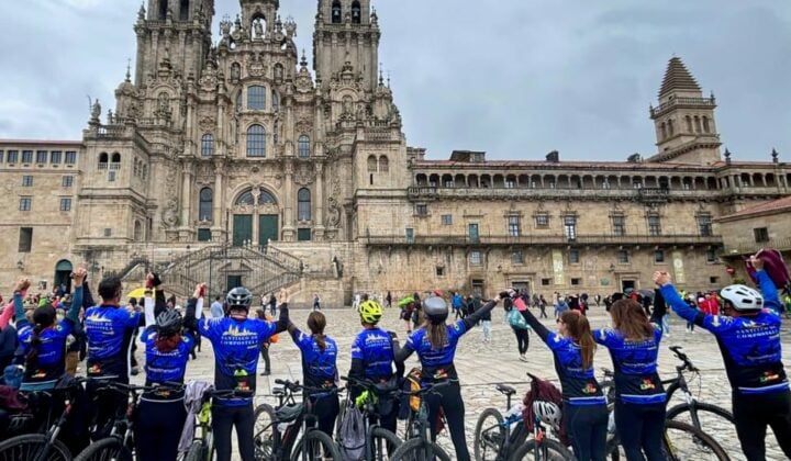 Image 3: Cycling group celebrating their arrival at Santiago Cathedral