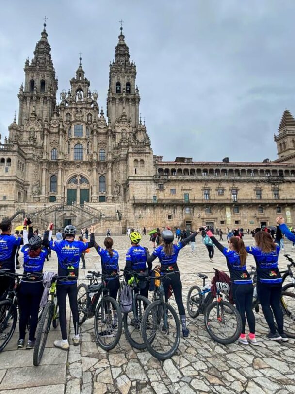 Image 3: Cycling group celebrating their arrival at Santiago Cathedral
