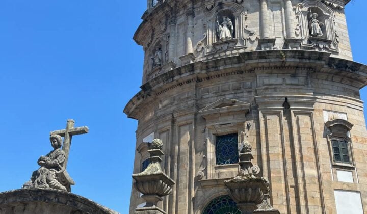 Image 5: Historic church tower along the Camino beneath a clear blue sky