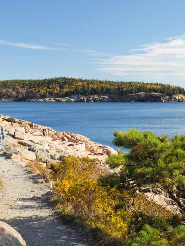person hiking on the coast of acadia